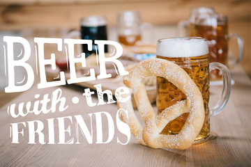 Wall Mural - top view of fried sausages, onion rings, french fries, pretzels and mugs with beer on wooden table in pub with beer with the friends illustration