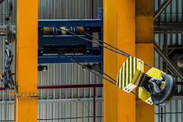 Overhead traveling crane with steel hooks in industrial engeenering plant shop. Steel slings. Bottom up view.