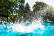 © Viktoriia - Summer Vacation. Young people by the pool jumping into water