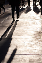 Unrecognizable People Walking On New York City Sidewalk With Light And Shadows. Copy Space Available.