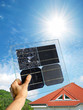Hand holding samples of various solar cells of polycrystalline and monocrystalline types