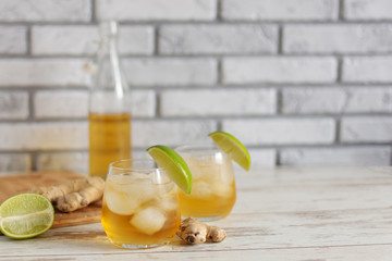 Wall Mural - Fresh Ginger Ale with lime and ice or Kombucha in Bottle - Homemade lemon and ginger organic probiotic drink.