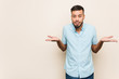 © Asier - Young south-asian man confused and doubtful shrugging shoulders to hold a copy space.