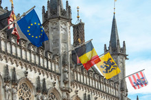 The 14th Cenury Stadhuis (City Hall) With National And Regional Flags, Burg Square, Brugge (Bruges), West Flanders, Belgium