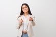 © Asier - Young business arab woman isolated against a white background cheerful smiles pointing to front.