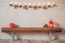 Cozy Rustic Christmas Composition In A Rural House With A Lantern And Red Bauble On An Old Wooden Log