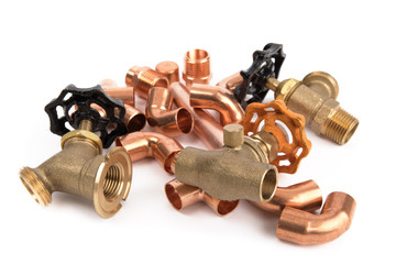 a pile of copper hot and cold water supply plumbing parts isolated on whiet