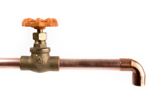 A Brass Plumbing Shut Off Valve With An Orange Handle Attached To A Copper Pipe With An Elbow Isolated On White