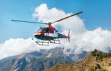 Medical Rescue helicopter landing in high altitude Himalayas mountains. Safety and travel insurance concept image.