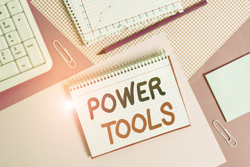 Poster - Writing note showing Power Tools. Business concept for tool that is actuated by additional power source and mechanism Writing equipments and computer stuffs placed above colored plain table