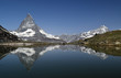the reflection of the Matterhorn on the surface of Riffelsee. Switzerland