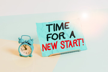 Wall Mural - Writing note showing Time For A New Start. Business concept for Trust the magic of Beginnings Afresh Anew Rebirth Alarm clock beside a Paper sheet placed on pastel backdrop