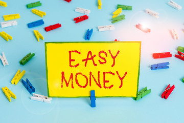 Word writing text Easy Money. Business photo showcasing money that is easily have and sometimes dishonestly earned Colored clothespin papers empty reminder blue floor background office pin