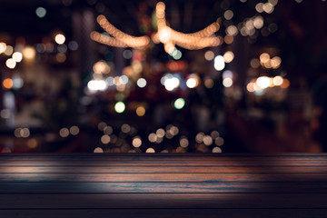 Wall Mural - top desk with blur restaurant background,Wooden table and blurred bokeh of night street background