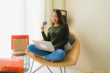 Portrait beautiful young asian women using computer laptop or smart and mobile phone with credit card for online shopping