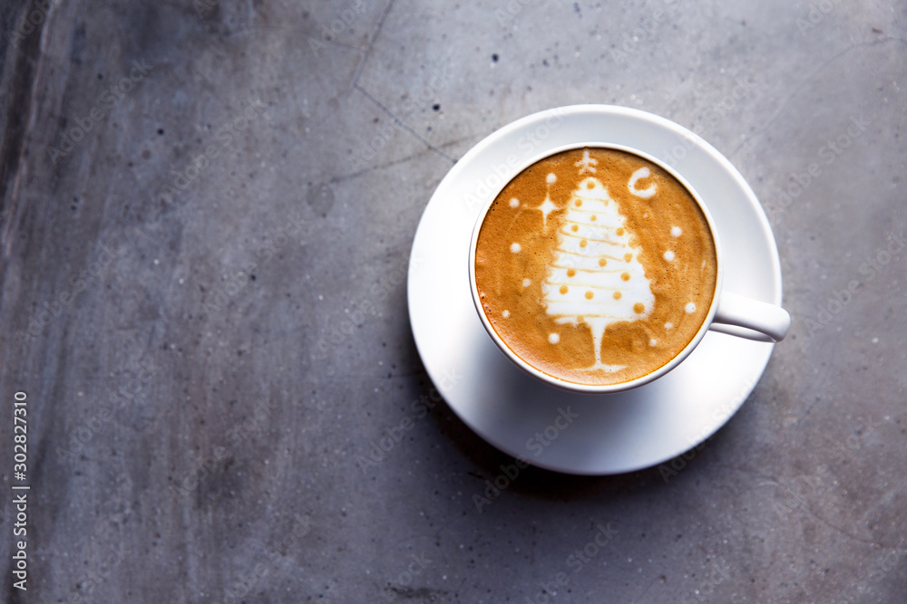Tasty cappuccino with Christmas tree latte art on grey concrete background. - obrazy, fototapety, plakaty 