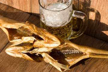 Oktoberfest holiday concept. Smoked fish and a glass of beer. Cold smoked pike perch on a dark rustic background.