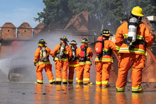 Firefighters Are Fighting Fire With A Fire Brigade, Firefighters Fighting Fire During Training With High Pressure Water To Fire.