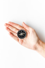 Wall Mural - Choose direction concept. Compass in hand on white background top view copy space