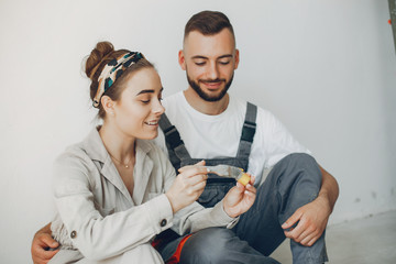 Family repairs. Couple at home. Woman in a overalls