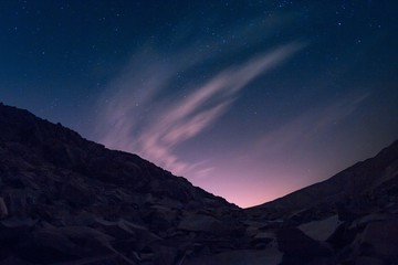 Wall Mural - hill with a lot of metal pieces under the starry sky with aurora