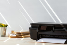 Front View Of A Black Printer Machine On A Table