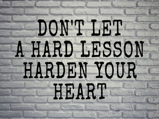 Wall Mural - Motivational and inspirational wording - Don’t Let A Hard Lesson Harden Your Heart. Blurred styled background.