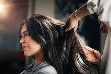 Hairstylist Fixing Woman’s Hair