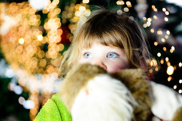 Wall Mural - pretty little girl in front admiring Christmas decoration