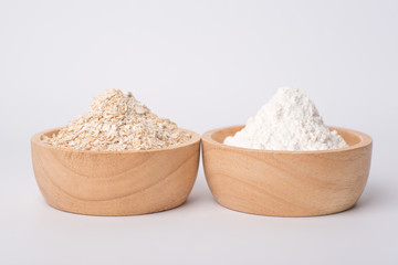 Close up of oat flake and wheat flour prepared for cooking on a white background