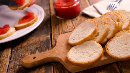 Wall Mural - bread toast with caviar, woman preparing festive toast