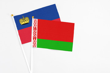 Belarus and Liechtenstein stick flags on white background. High quality fabric, miniature national flag. Peaceful global concept.White floor for copy space.