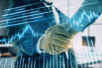 multi exposure of financial graph on office background with two businessmen handshake. concept of su