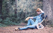 © alexkich - Male lumberjack in the forest. A professional woodcutter inspects trees for felling.