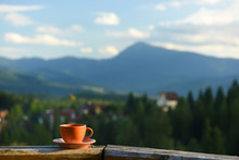 Cup With Tea On A Background Of A Mountain Landscape. The Atmosphere Of Travel And Relaxation.
