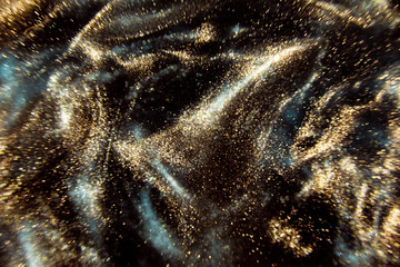 abstract black and gold festive glitter shimmering water luxury background. de-focused
