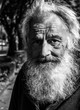 © Srdjan - Close up portrait of old homeless alcoholic man face with white beard and hair wandering on the street depressed sick and lonely, social issues documentary concept black and white