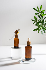 Wall Mural - natural cosmetic skincare or essential oil bottles container and green leaf on white background. hom