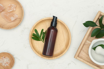 Wall Mural - natural cosmetic skincare bottle container and organic green leaf. beauty product concept