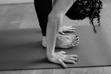 Canvas Print - Hispanic yoga woman practicing in studio photographed in black and white. 