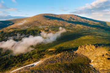 Wall Mural - Aerial view of Mount Sarlyk in Altai Mountains with dramatic light at sunset. Summer nature landscape in Siberia, Russia