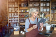 © pikselstock - Senior craftswoman with tablet computer in art studio