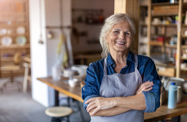 Wall Mural - Portrait of senior female pottery artist in her art studio