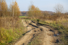 Soil Road With Muddy Tracks In Countryside