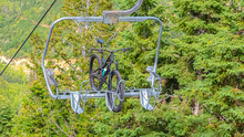 Panorama Mountain Bike On A Lift Against Trees In Park City Ski Resort During Off Season