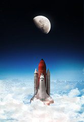 Leinwandbilder - Space shuttle launch in outer space from Earth. Moon on background, Rocket on orbit of the planet. Border of blue sky with clouds and dark deep space. .Elements of this image furnished by NASA 