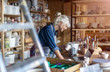 © pikselstock - Portrait of senior female pottery artist in her art studio