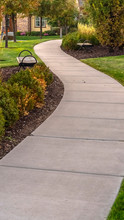 Vertical Frame Paved Walkway Through A Landscaped Garden Day