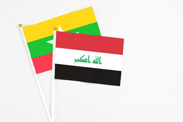 Iraq and Myanmar stick flags on white background. High quality fabric, miniature national flag. Peaceful global concept.White floor for copy space.