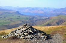 Pile Of Stones, Or Cairn, On Blencathra In The English Lake District, With Derwent Water In The Distance